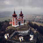 Aerial view of historical church atop on hill. Late baroque calvary in Banska Stiavnica in Slovakia | SUPERPOBYT Travel