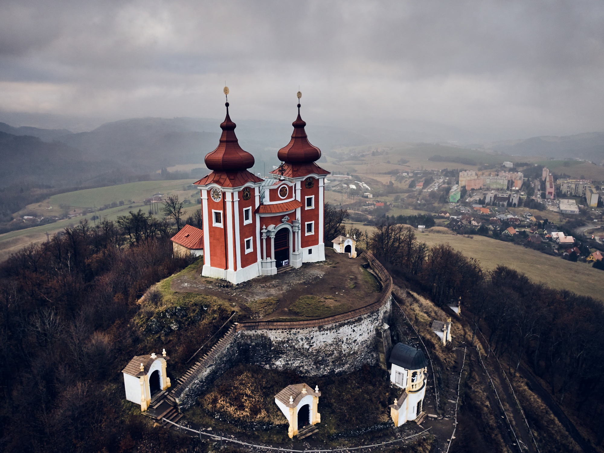 Aerial view of historical church atop on hill. Late baroque calvary in Banska Stiavnica in Slovakia | SUPERPOBYT Travel