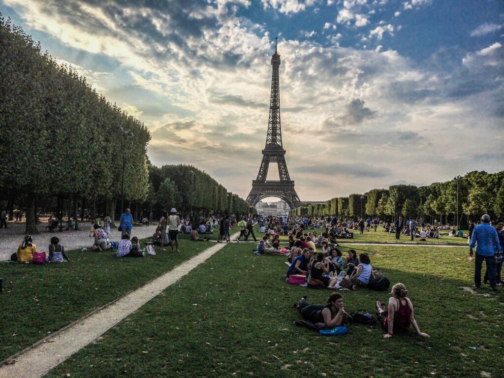 At the Eiffel tower in Paris, FranceGorgeous white girl posing in amusement park with kissing face expression | SUPERPOBYT Travel