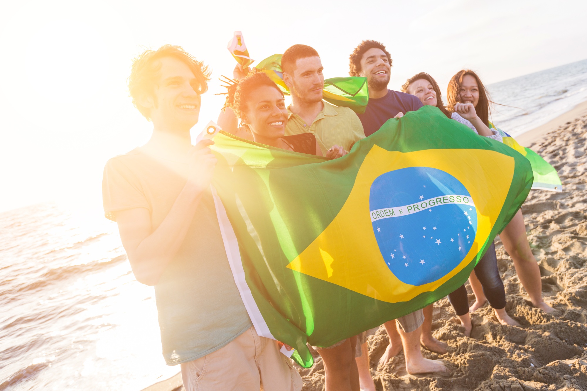 Group of Friends with Brazilian Flag at Beach | SUPERPOBYT Travel