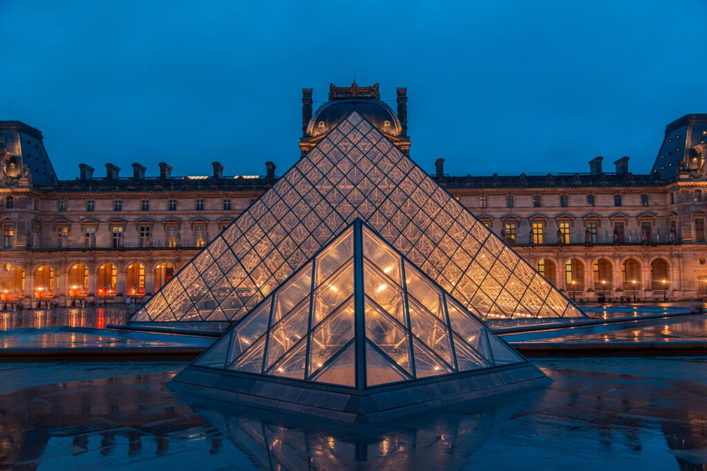 Amazing view from a Louvre Pyramid from a dark and moody day with rainy weather.