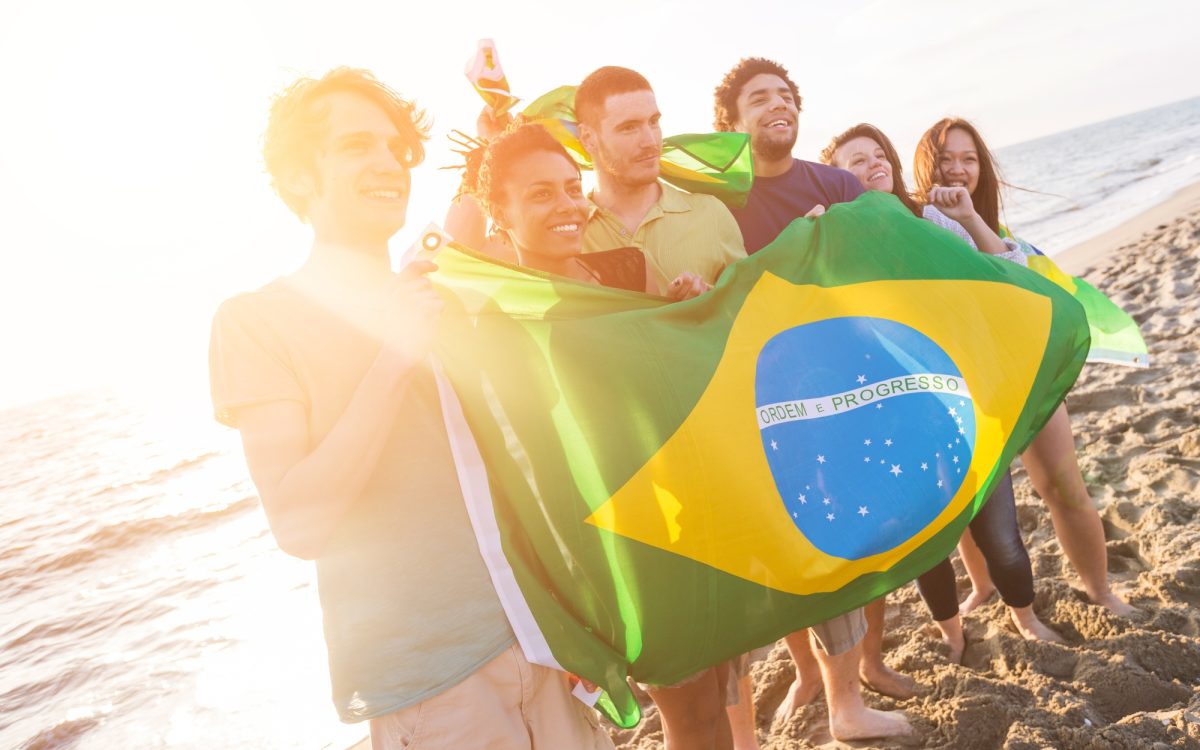 Group of Friends with Brazilian Flag at Beach | SUPERPOBYT Travel